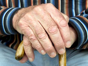 hands of senior with cane