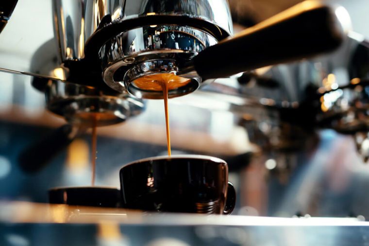 Close-up of espresso pouring from coffee machine. Professional coffee brewing