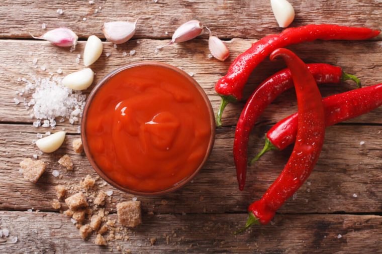 Freshly prepared Sriracha Hot chilli Sauce close-up on the table. horizontal view from above