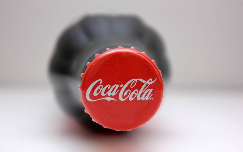 https://www.rd.com/wp-content/uploads/2018/02/The-Real-Reason-the-Coca-Cola-Logo-is-Red_570538087_tok-anas-ft.jpg?fit=700,1024