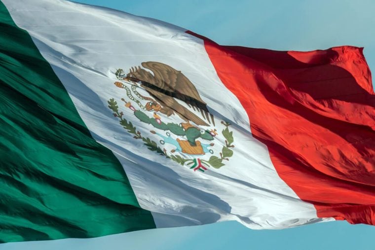 Mexican flag weaving on sky background