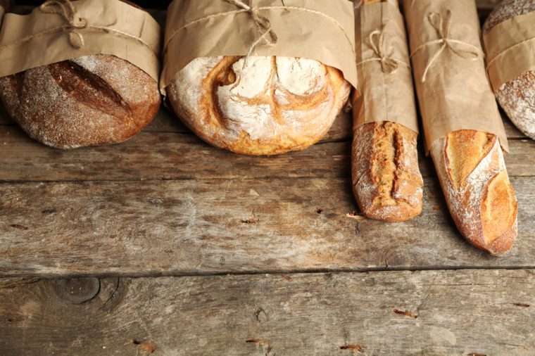 Different fresh bread, on old wooden table