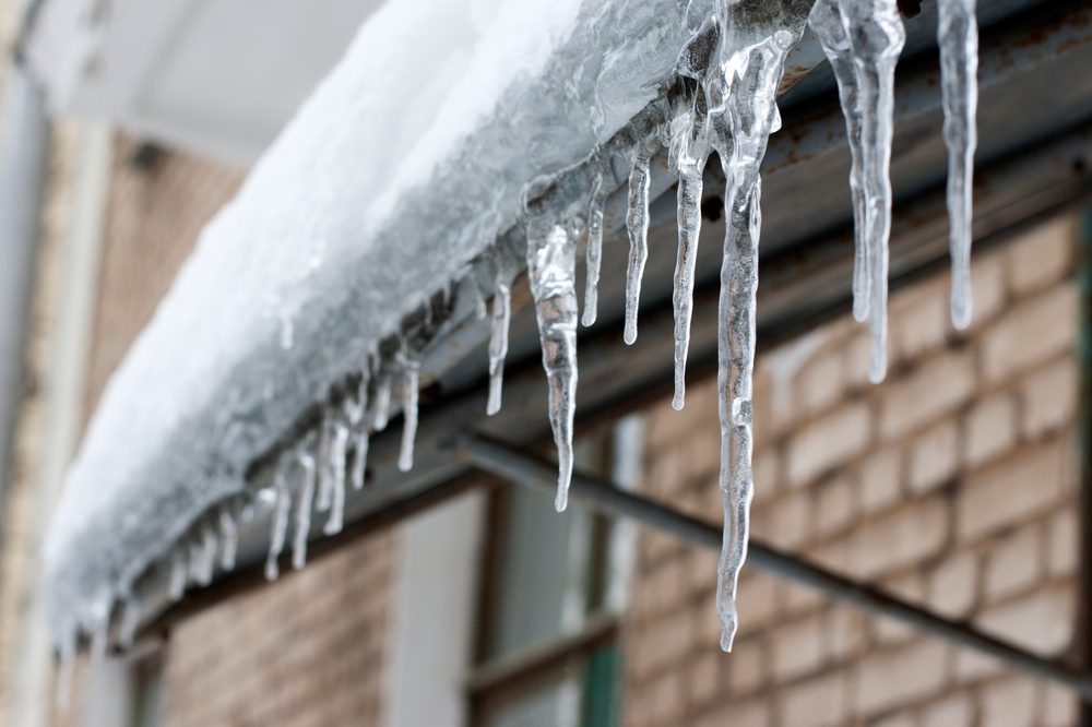 icicles which are hanging down from a roof