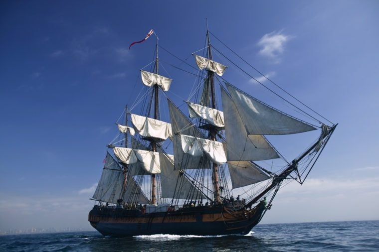 Tall Ship under sail with the shore in the background