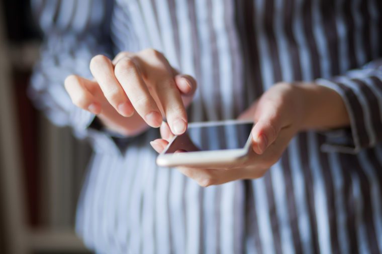 Young woman using a touchscreen smartphone.