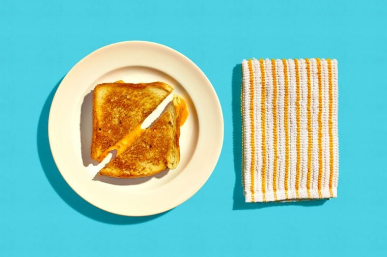 Grilled Cheese Sandwich on a Plate on a Blue Background