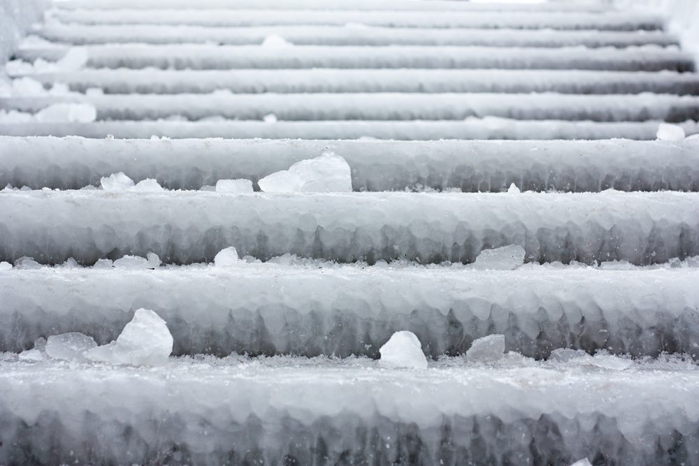 Stairs on the boardwalk covered with ice from the cold Russian winter