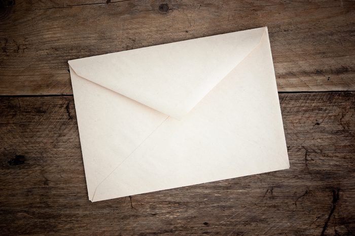 old postal envelope on wooden background