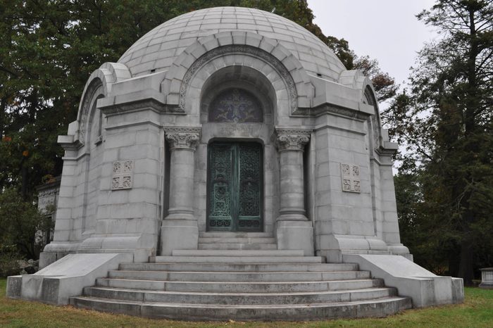 Round Mausoleum with Decorative Iron Doors in a Cemetery