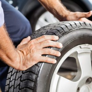 Mechanic Holding Car Tire At Garage; Shutterstock ID 429761875