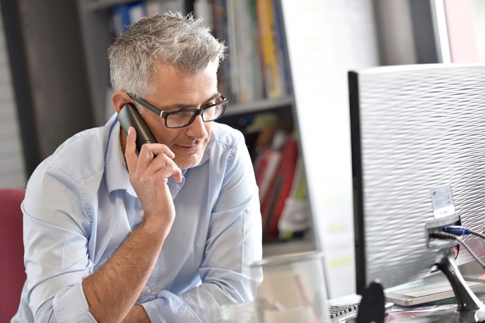 Businessman in office talking on phone