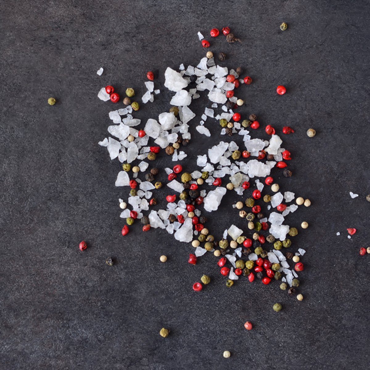 A mixture of peppers and salt on shale stone.