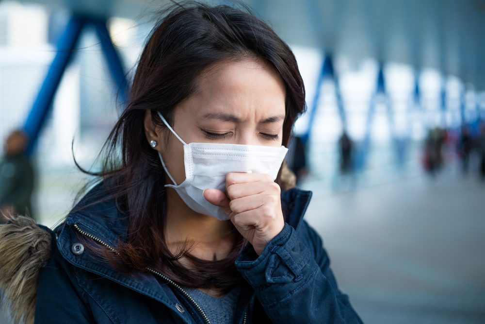 Woman suffer from cough with face mask protection