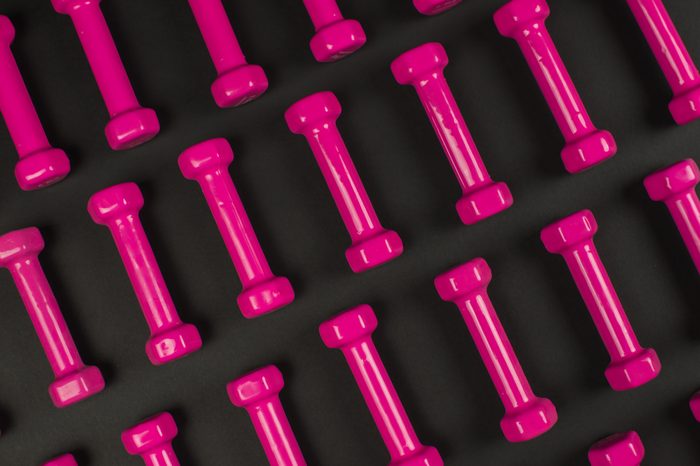 pink dumbbels isolated on black.