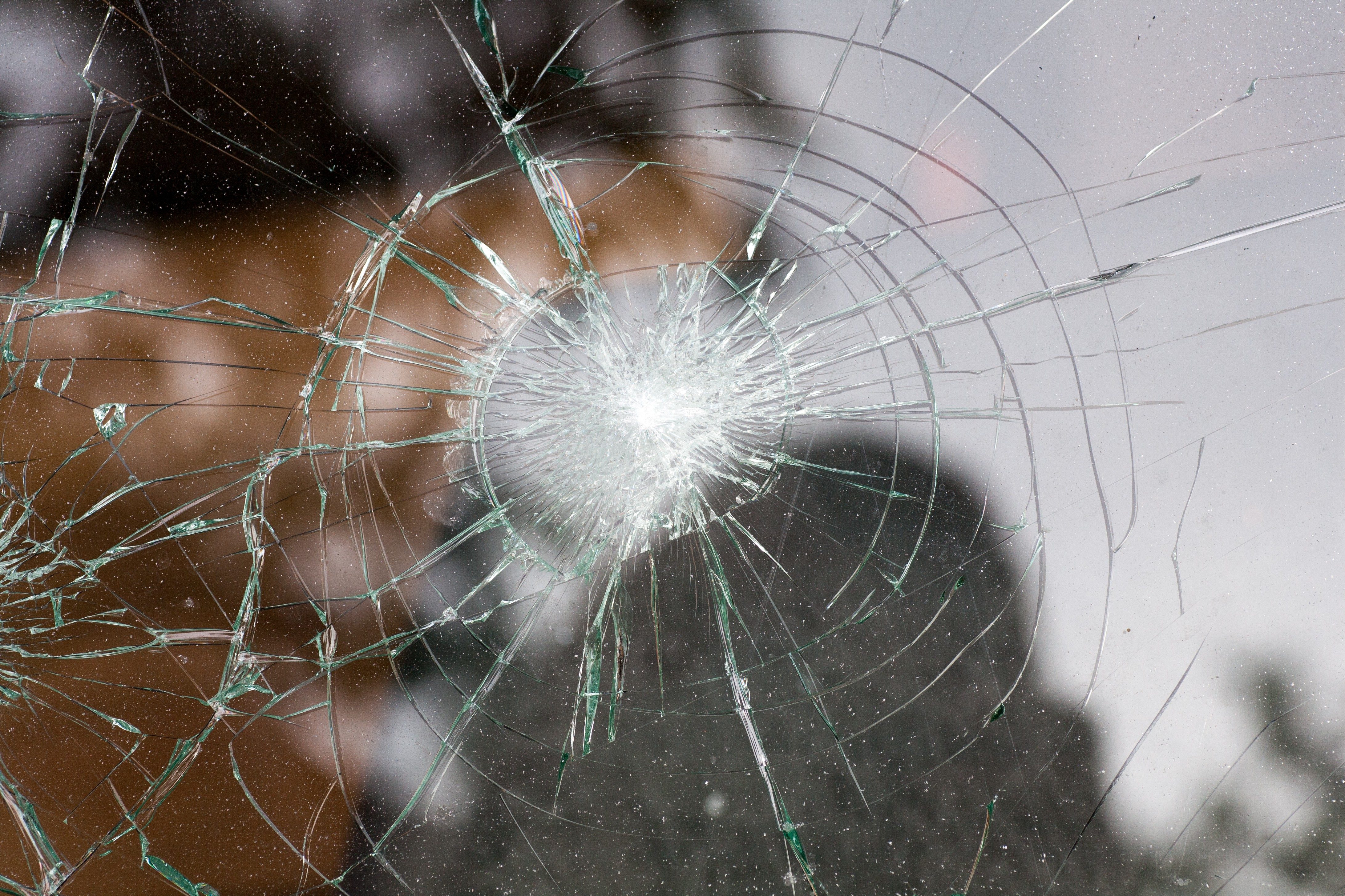 broken glass of a car with cracks in a circle