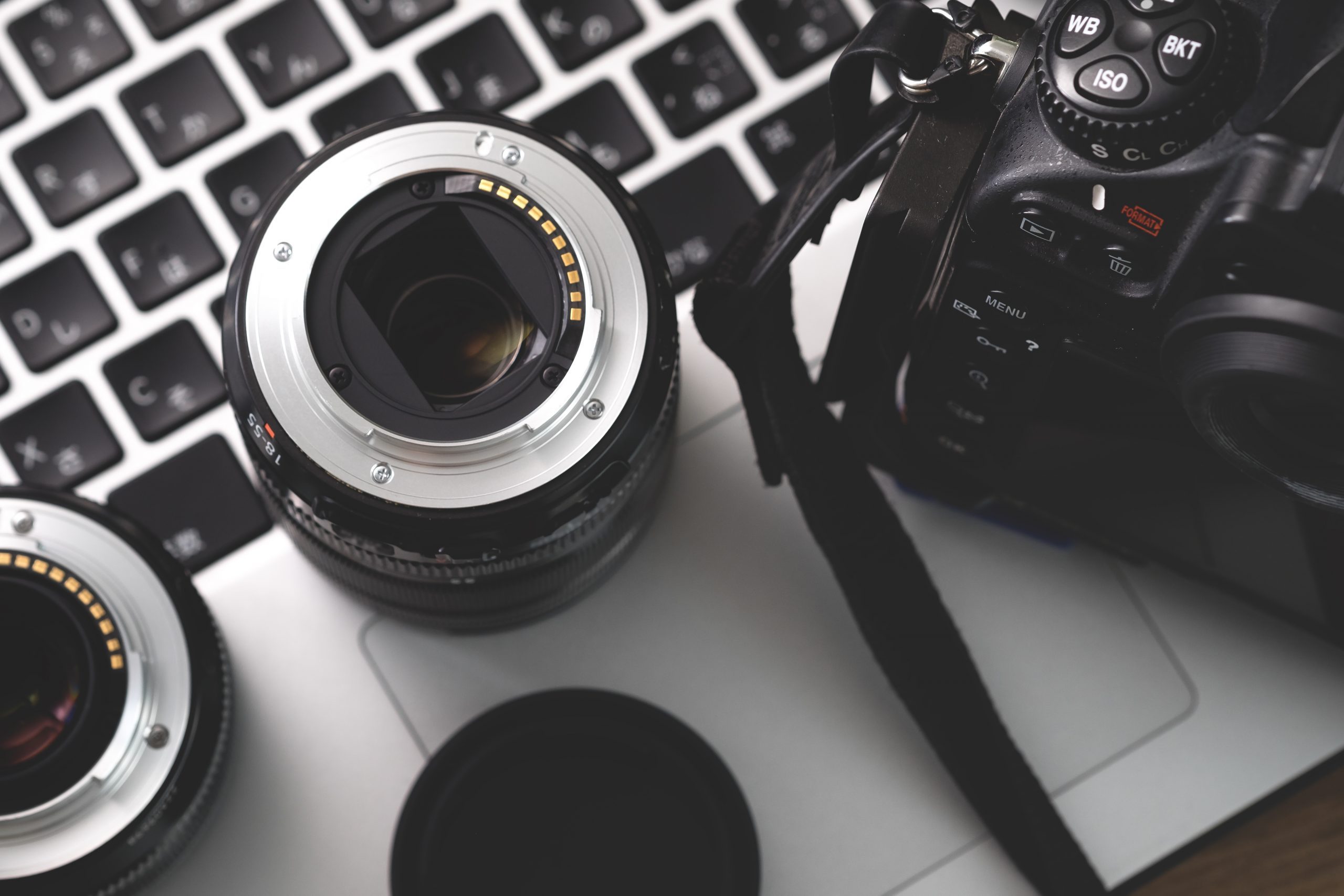 Digital camera, lens and laptop. concept of photographer work station.