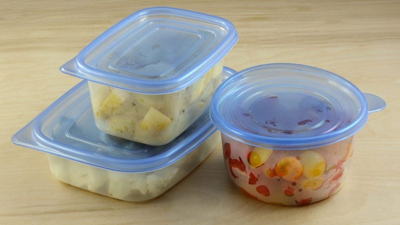 Chopped dinner ingredients of cauliflower, potatoes and cherry tomatoes in plastic refrigerator storage containers prepared in advance for quicker cooking during week after work