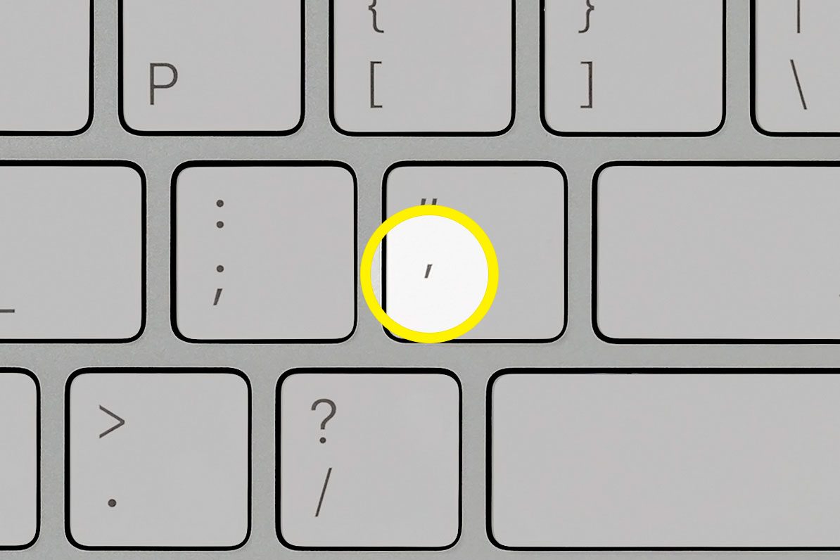 close up of computer keyboard with apostrophe key highlighted