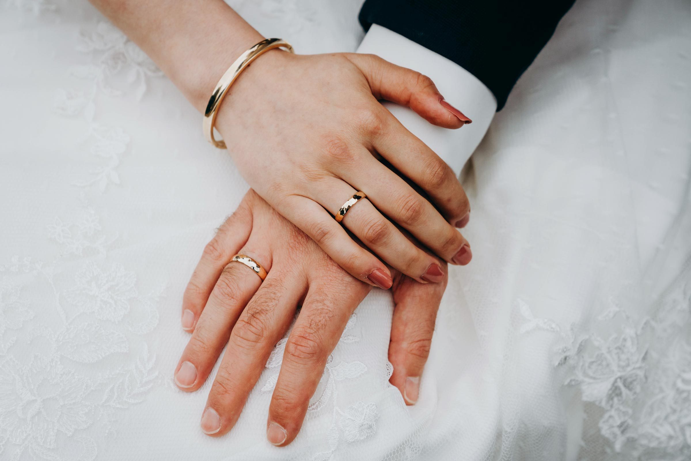 Couples Hands With Wedding Rings GettyImages 1359477117 MLedit 