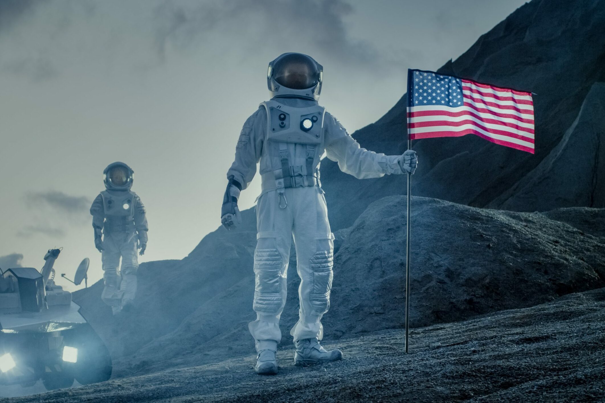 Two Proud Astronauts Plant American Flag on the Alien Planet. In the Background Research Base and Rover.