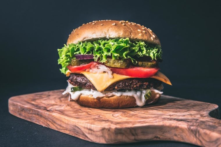 delicious burger on artisan wood cutting board