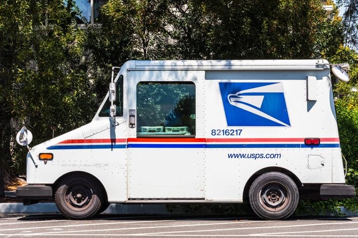 USPS vehicle parked on the side of the road