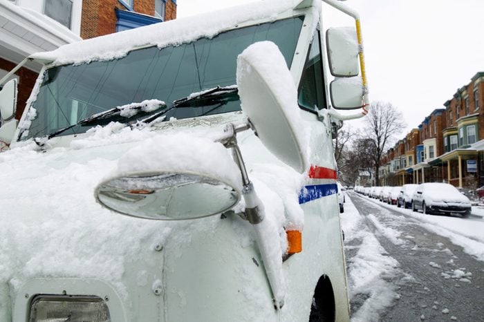 Snow Covered postal truck on a residential street in philadelphia