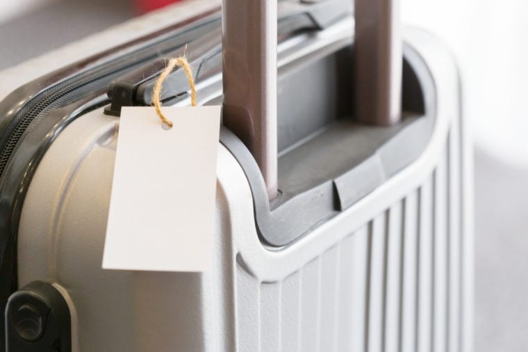 Close up of blank luggage tag label on a suitcase