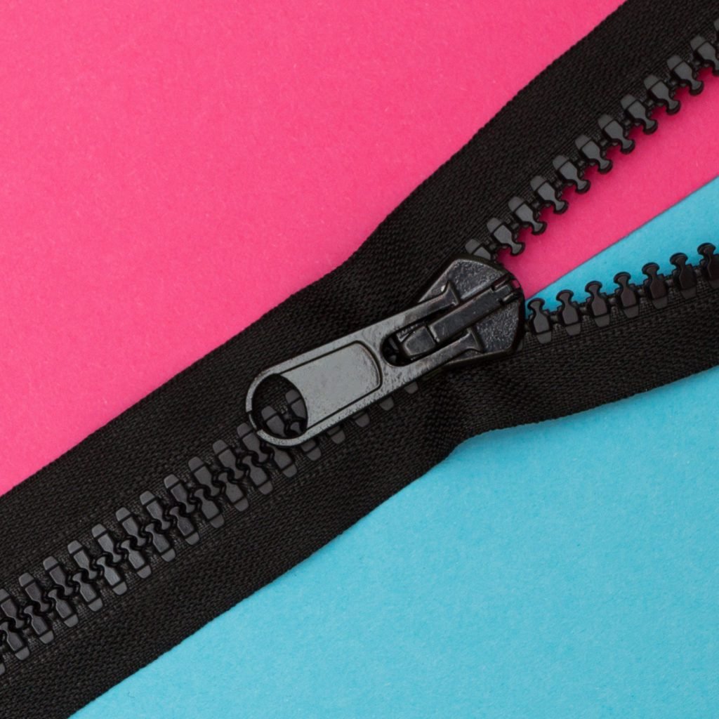 black zipper on pink and blue background