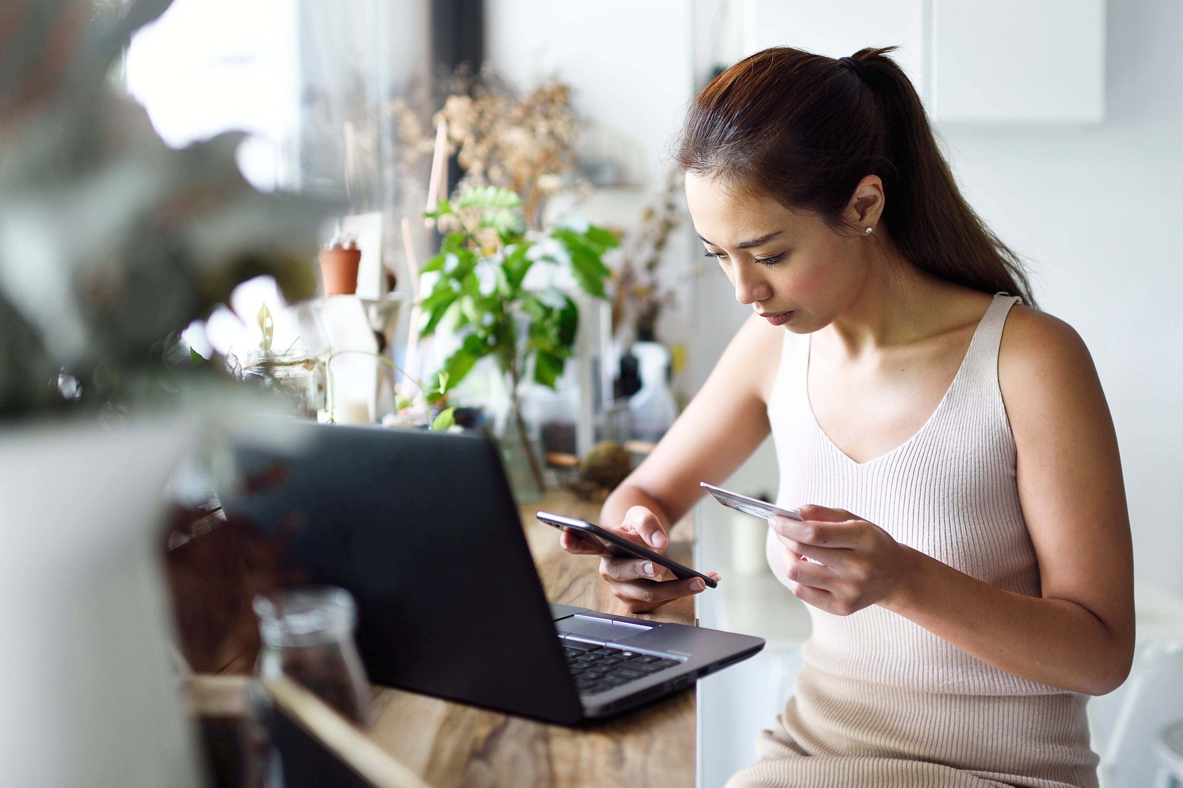 Beautiful woman online shopping in a cafe