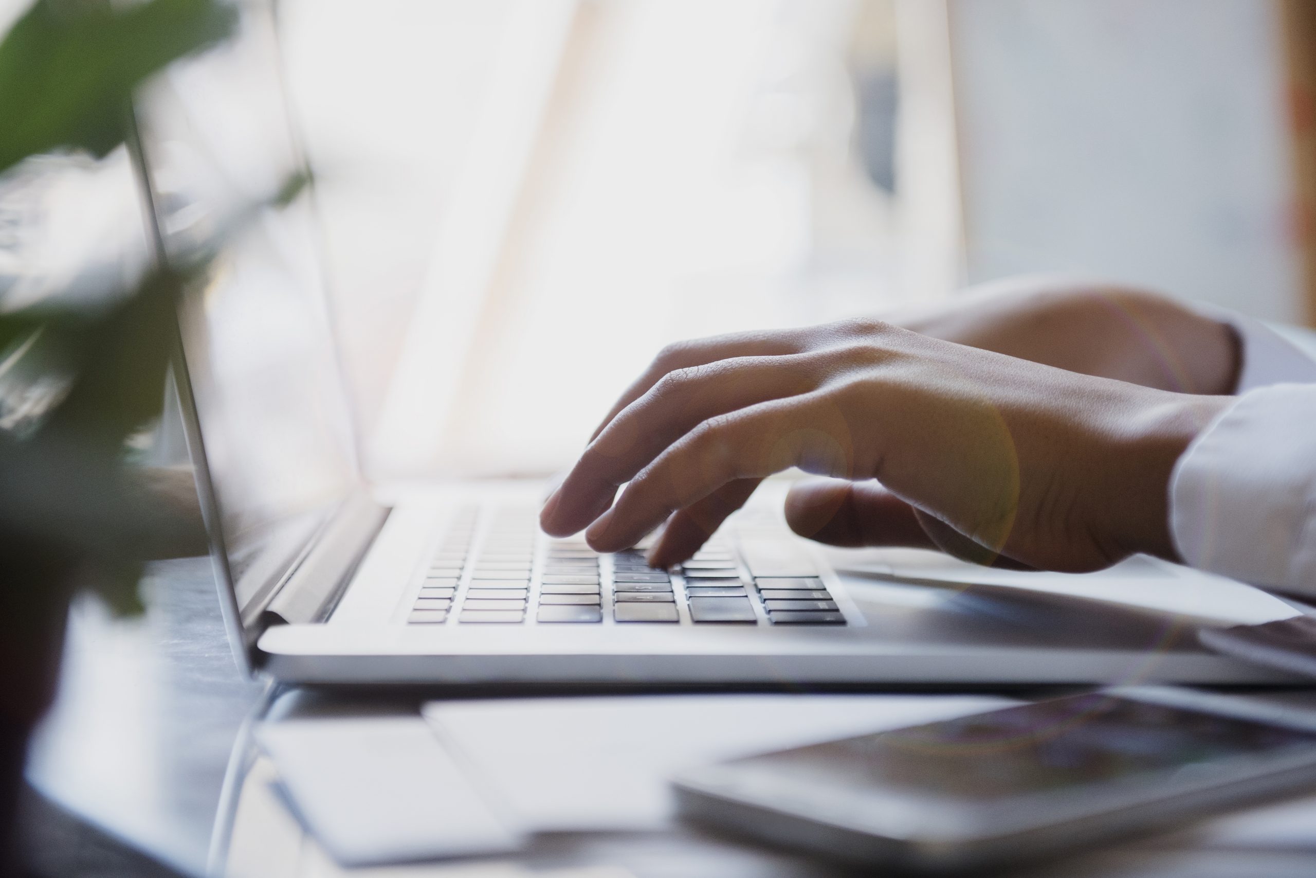 Hands of African American woman typing on laptop