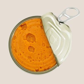 canned pumpkin on a tan background