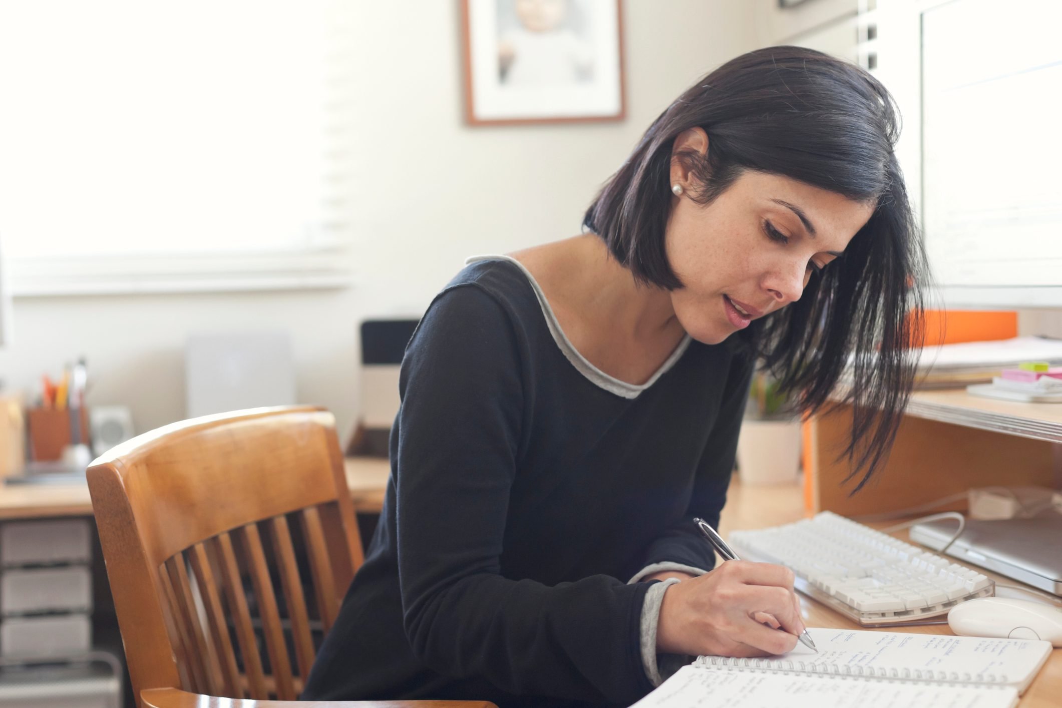 Hispanic woman working in home office