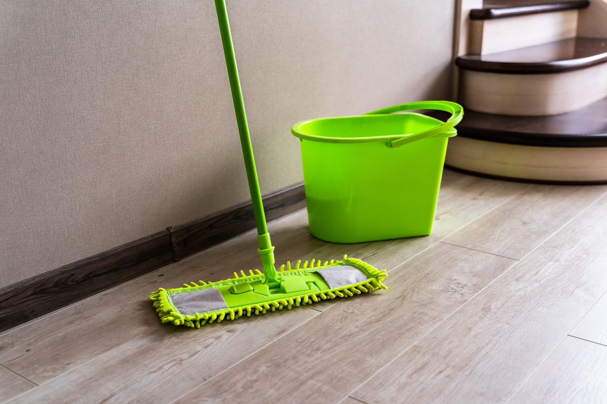 Mop with green microfiber rag, green plastic handle and bucket.