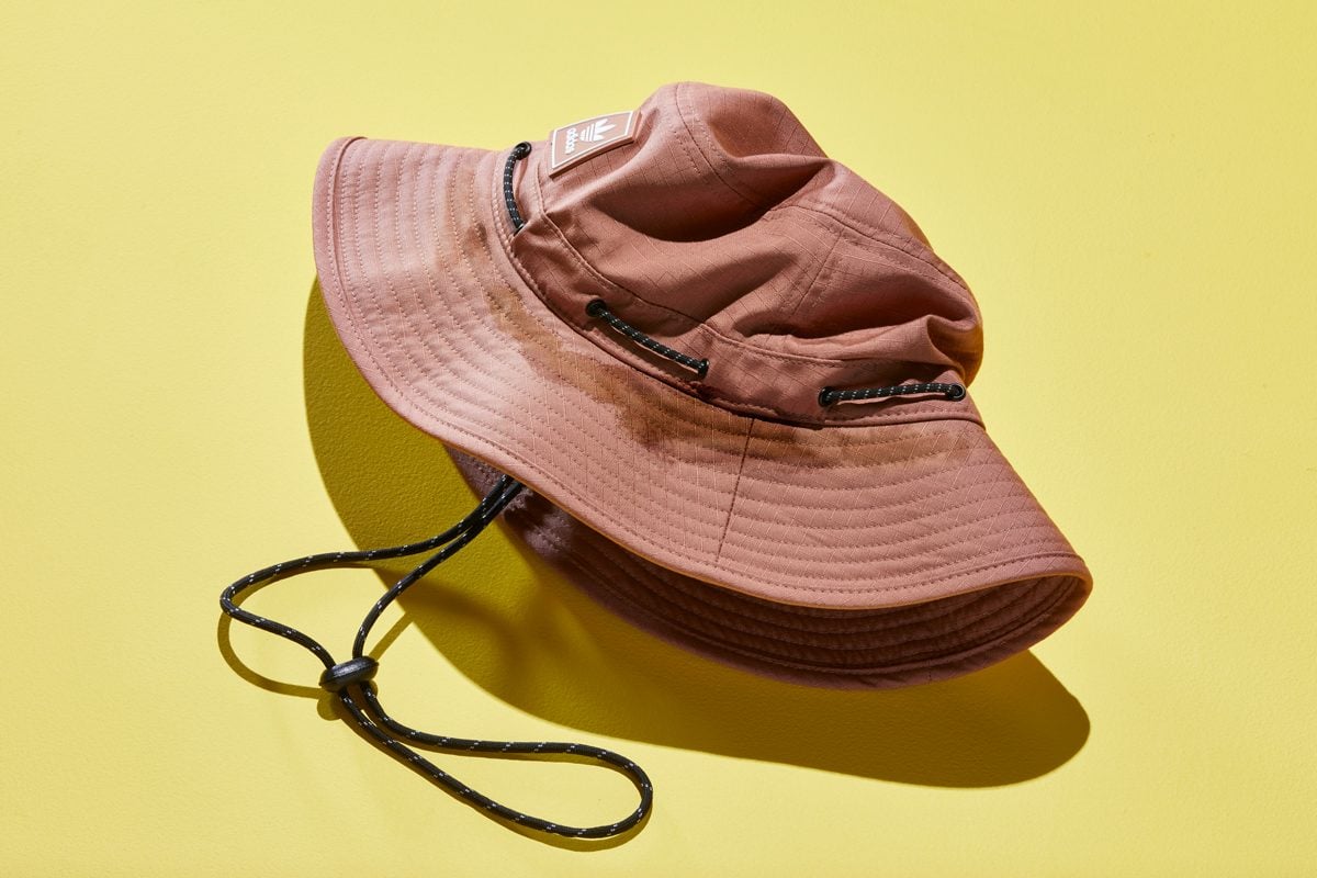 brown bucket hat with sweat stains on a yellow background