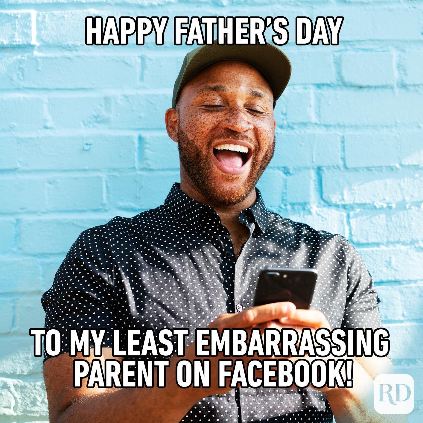 Man laughing at phone. Meme text: Happy Father's Day to my least embarrassing parent on Facebook!