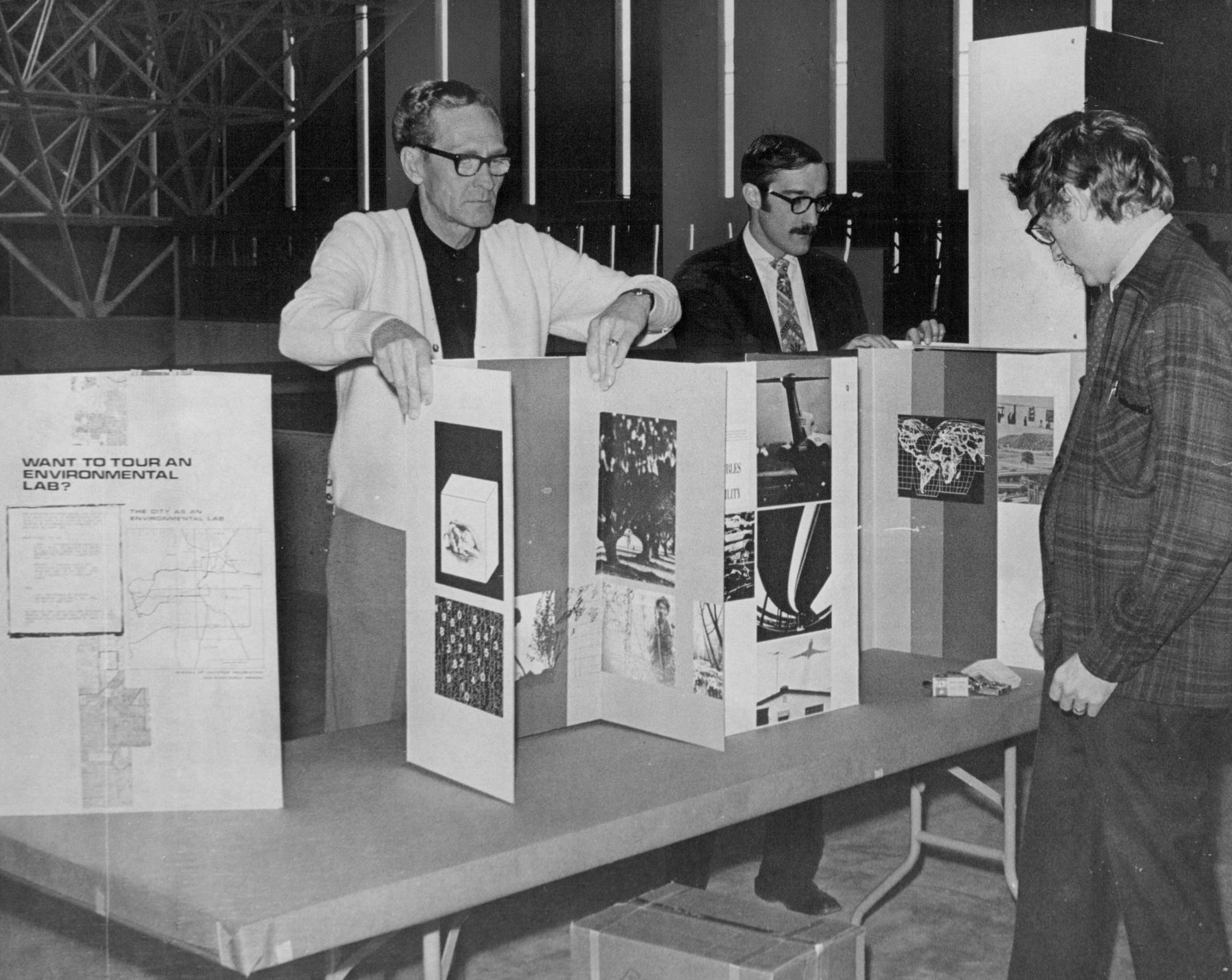 Preparations for Earth Day Teach - In Start; Readying a display booth at Currigan Hall are, from left. Charles Petersen, project officer, and Ed Harris and Bob Page, recreation resource specialists with the U.S. Department of the Interior Bureau of Outdoor Recreation; April 1970.