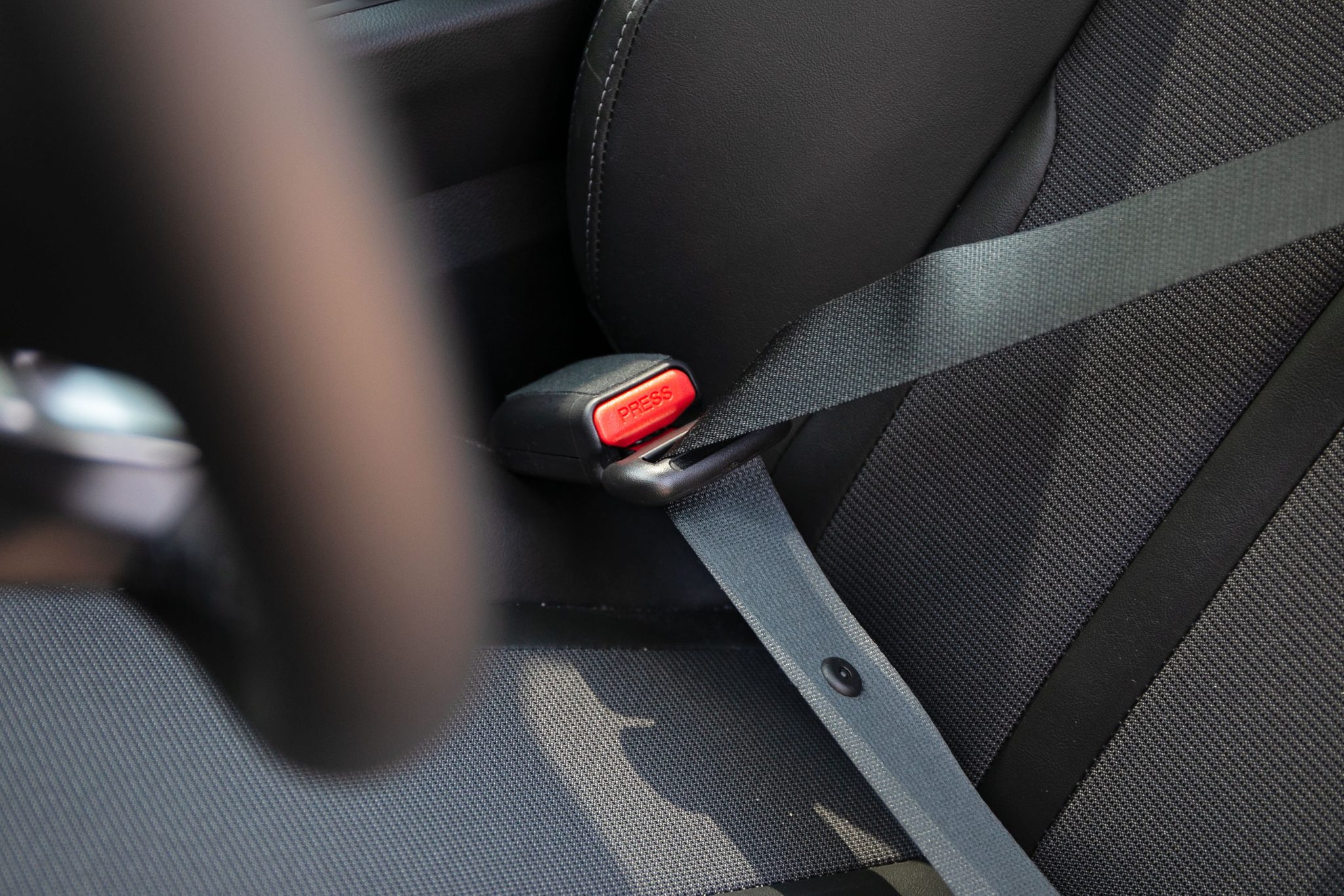 Why Your Seatbelt Has a Fabric Loop—And the Driver’s Seatbelt Doesn’t