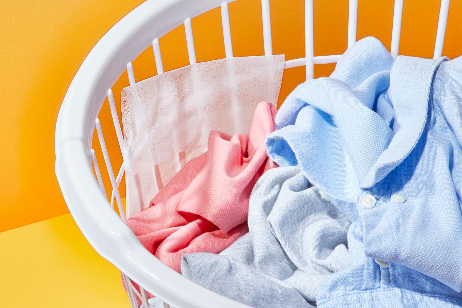 dryer sheet in a laundry basket with laundry