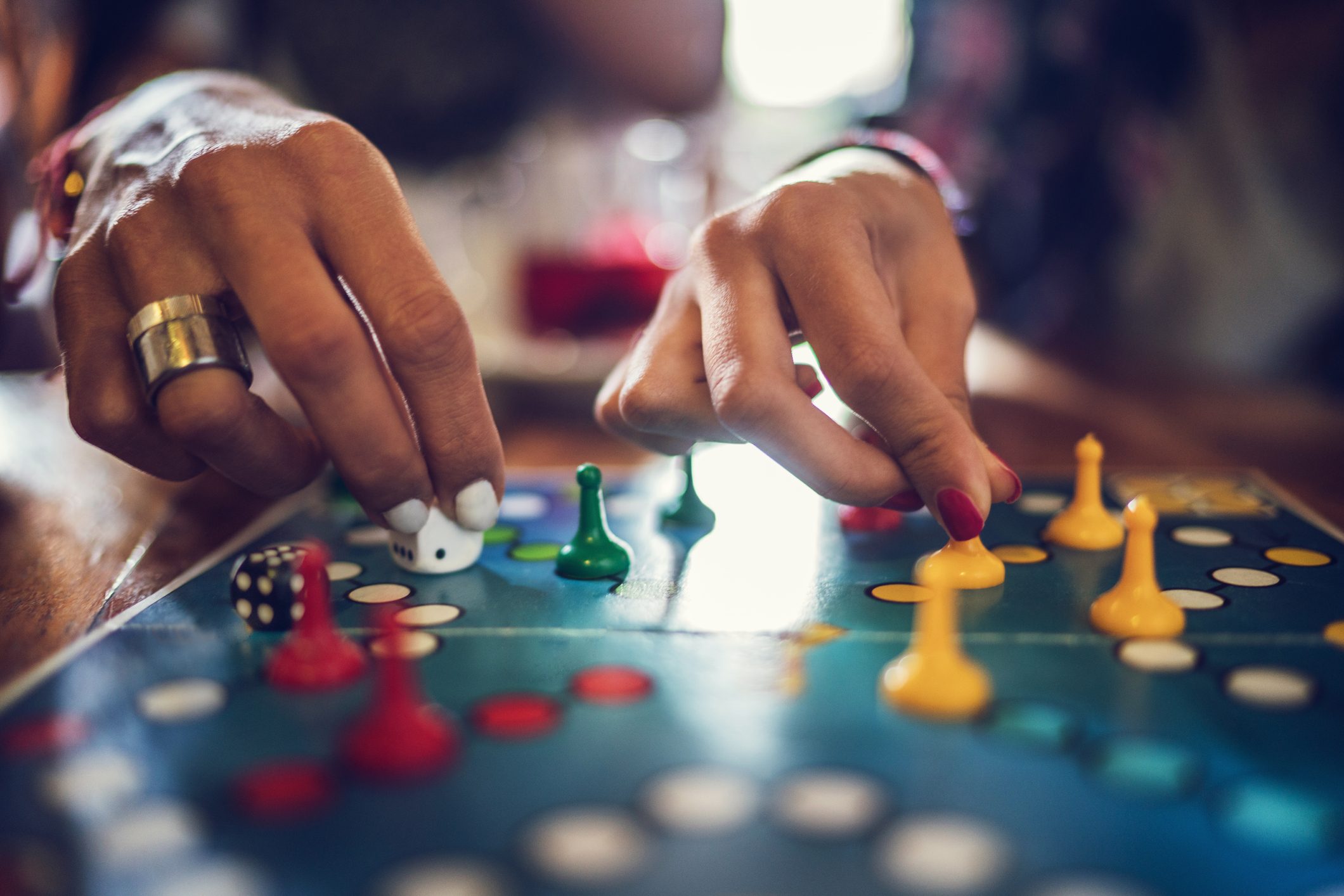 Close up of people playing board game