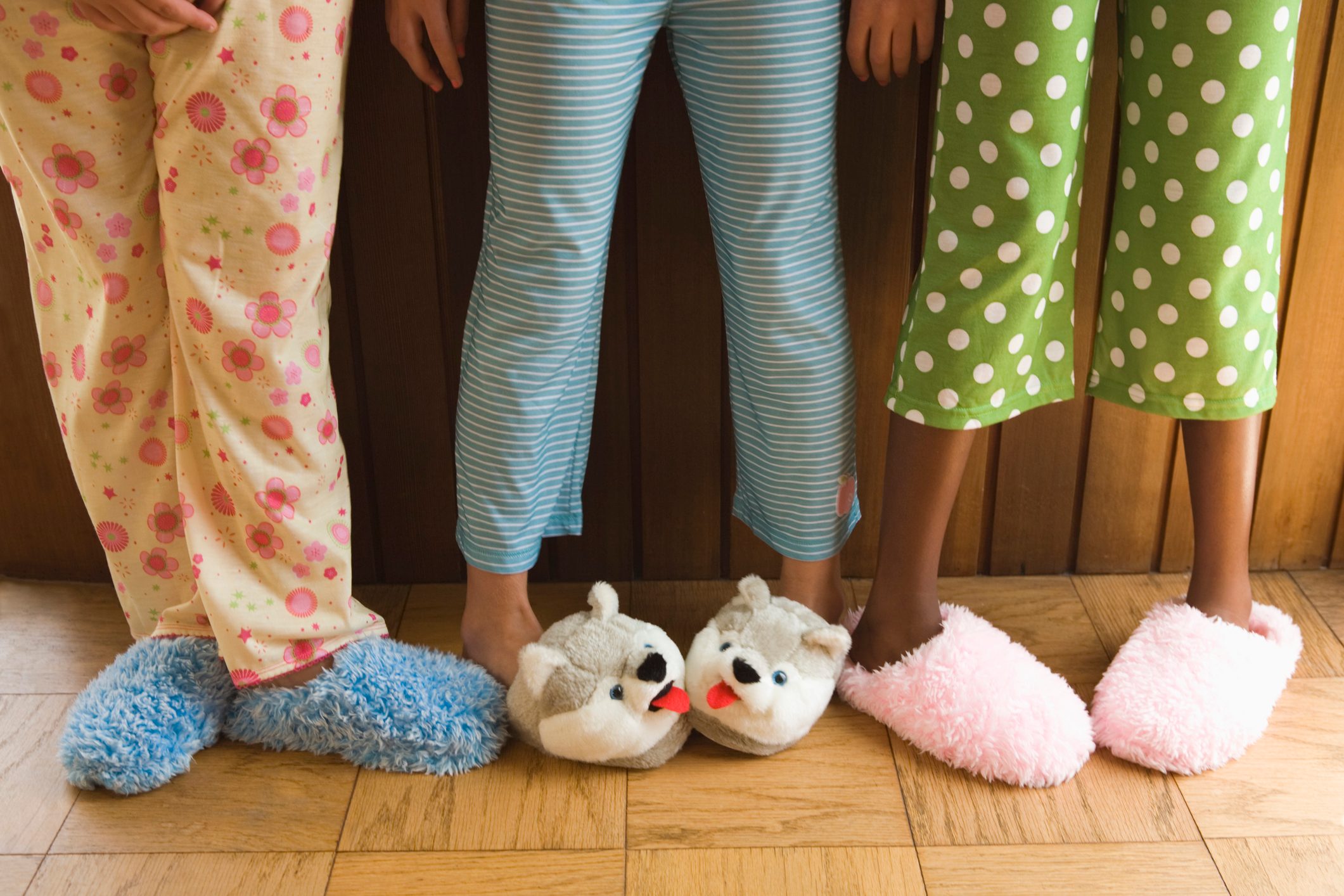 close up of young girls wearing slippers and pajamas