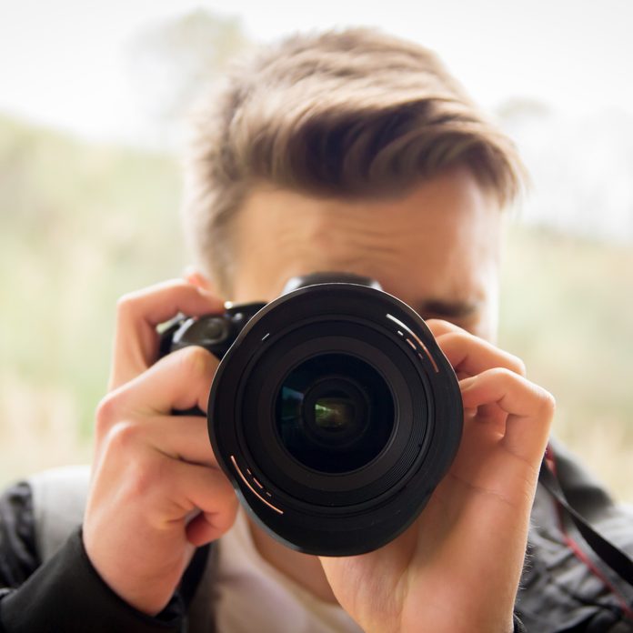 photographer taking a photo asking to 