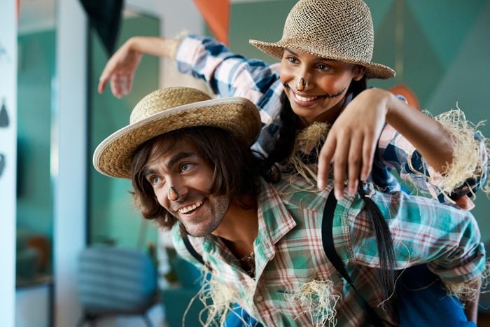 Shot of a young couple dressed in halloween costumes being being playful at home