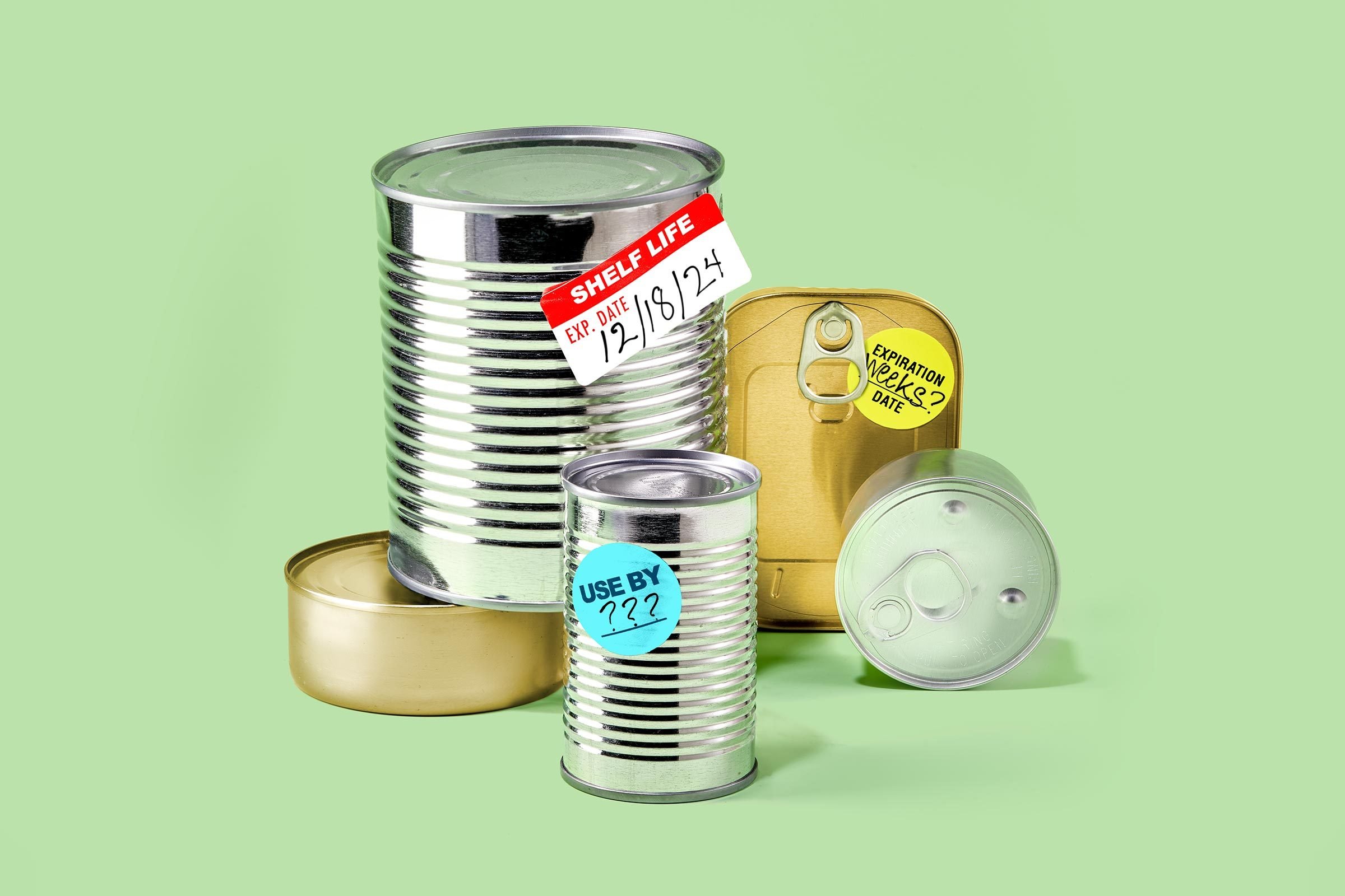 Food cans and tins on the shelf of a store cupboard Stock Photo
