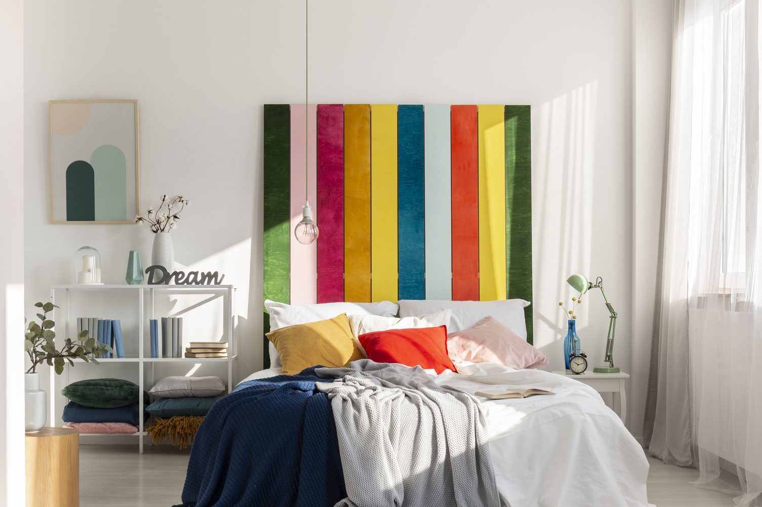 Colorful bedroom interior with rainbow colored bedhead