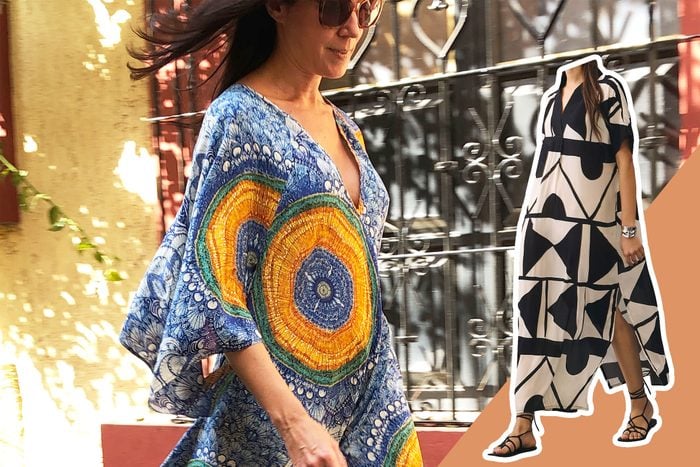 woman walking down the street wearing a kaftan style dress