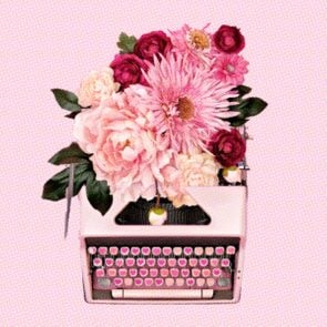pink typewriter with bouquet of flowers coming from the top