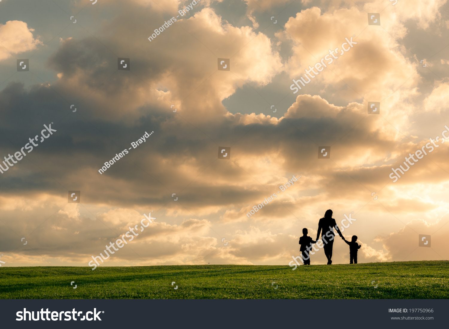 Stock Photo Family Silhouette Against A Bright Cloudy Sky At Sunset Mother And Two Boys Walking Holding Hands 197750966