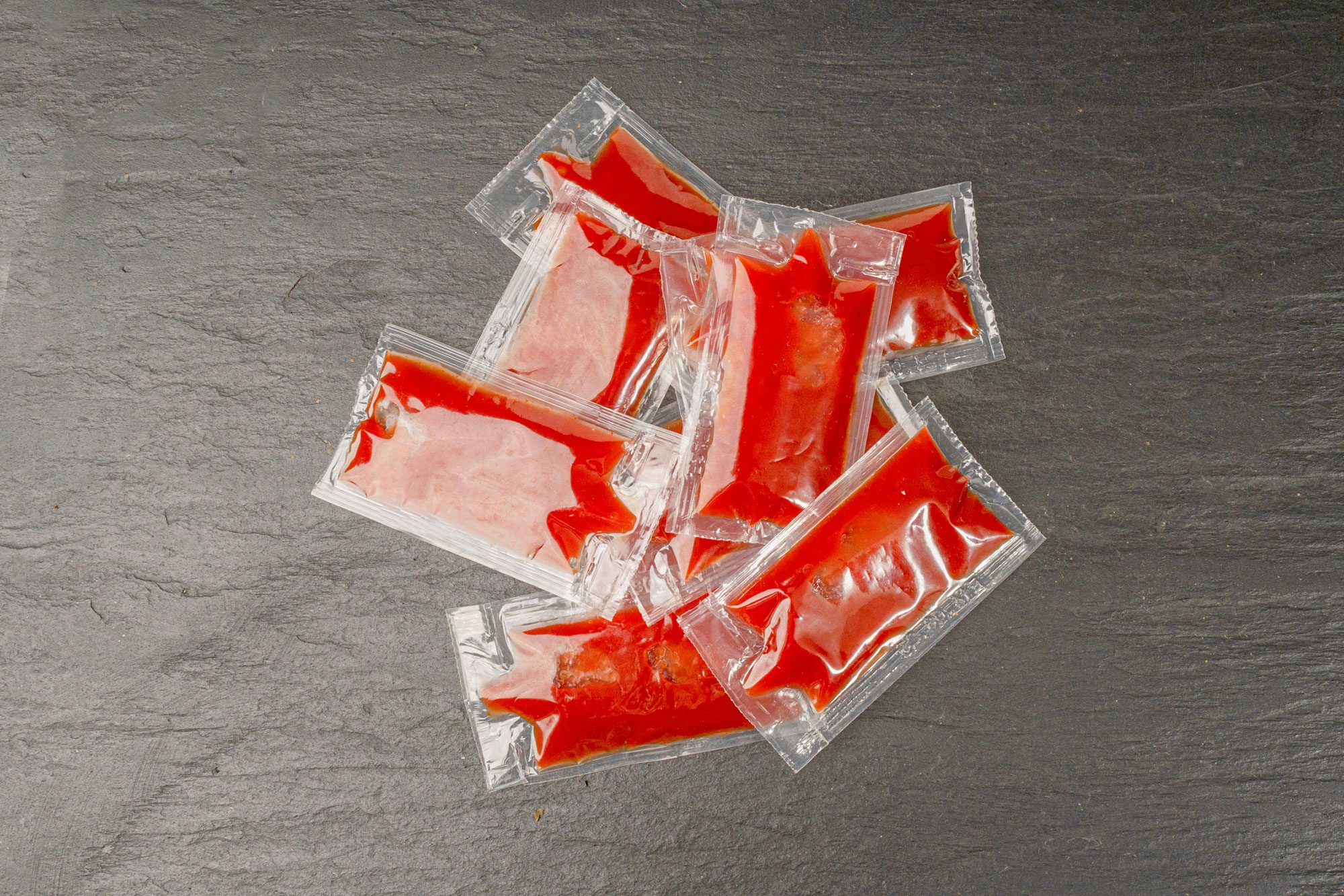 Ketchup in Square Plastic Bag on Black