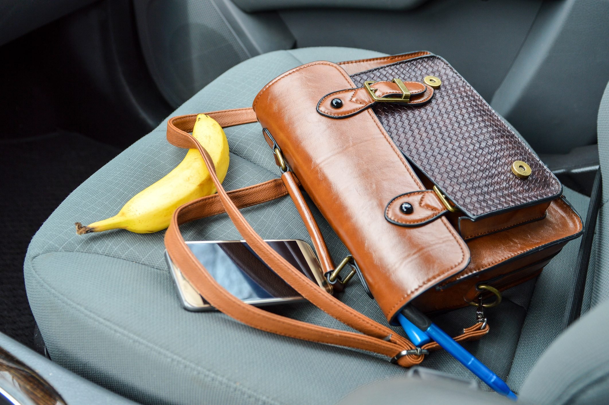 Purse and Accessories Laid Out on Passenger Seat of Car